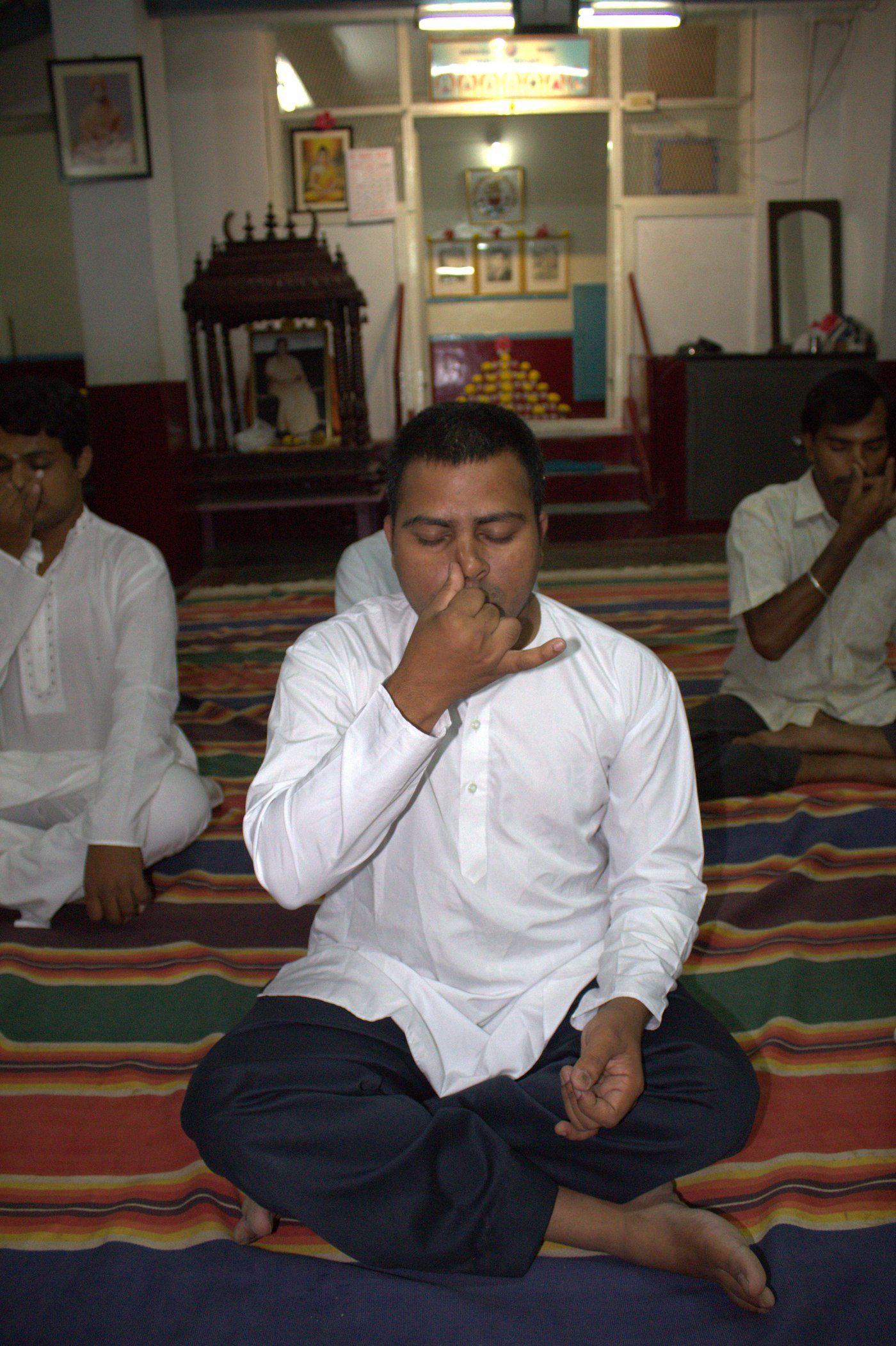 A practitioner performing Sankhya Pranayama, alternate nostril breathing